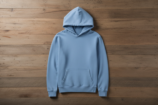 Pigment light blue hoodie on wooden background