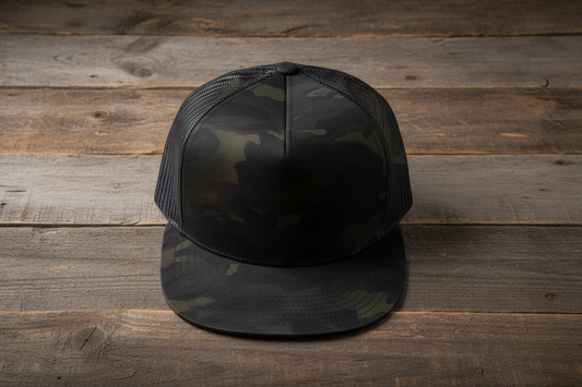 Dark camo trucker hat on wooden background
